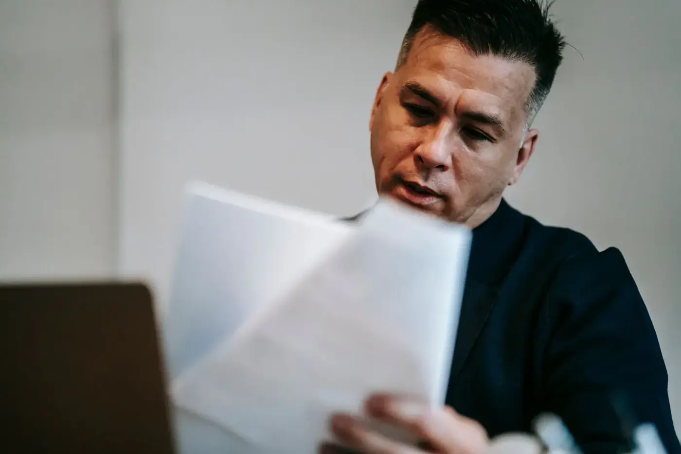 A bilingual team member working through paperwork at his desk