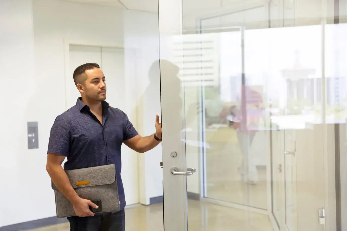 A payroll specialist arriving at the office with his case file