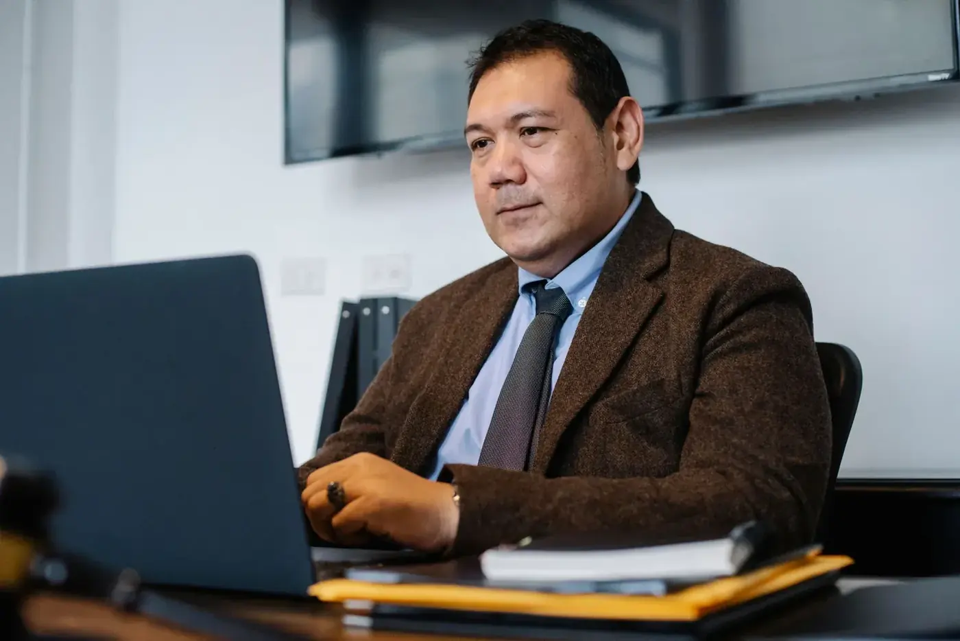 A bilingual virtual assistant working at his laptop in an office