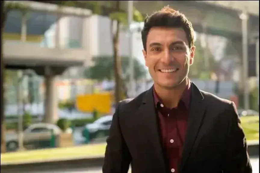 A bilingual account lead on the street outside his office